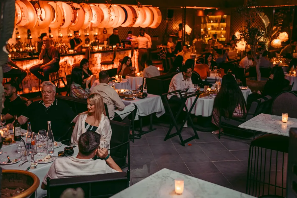 The LOV terrace full of guests dining beneath warm lanterns