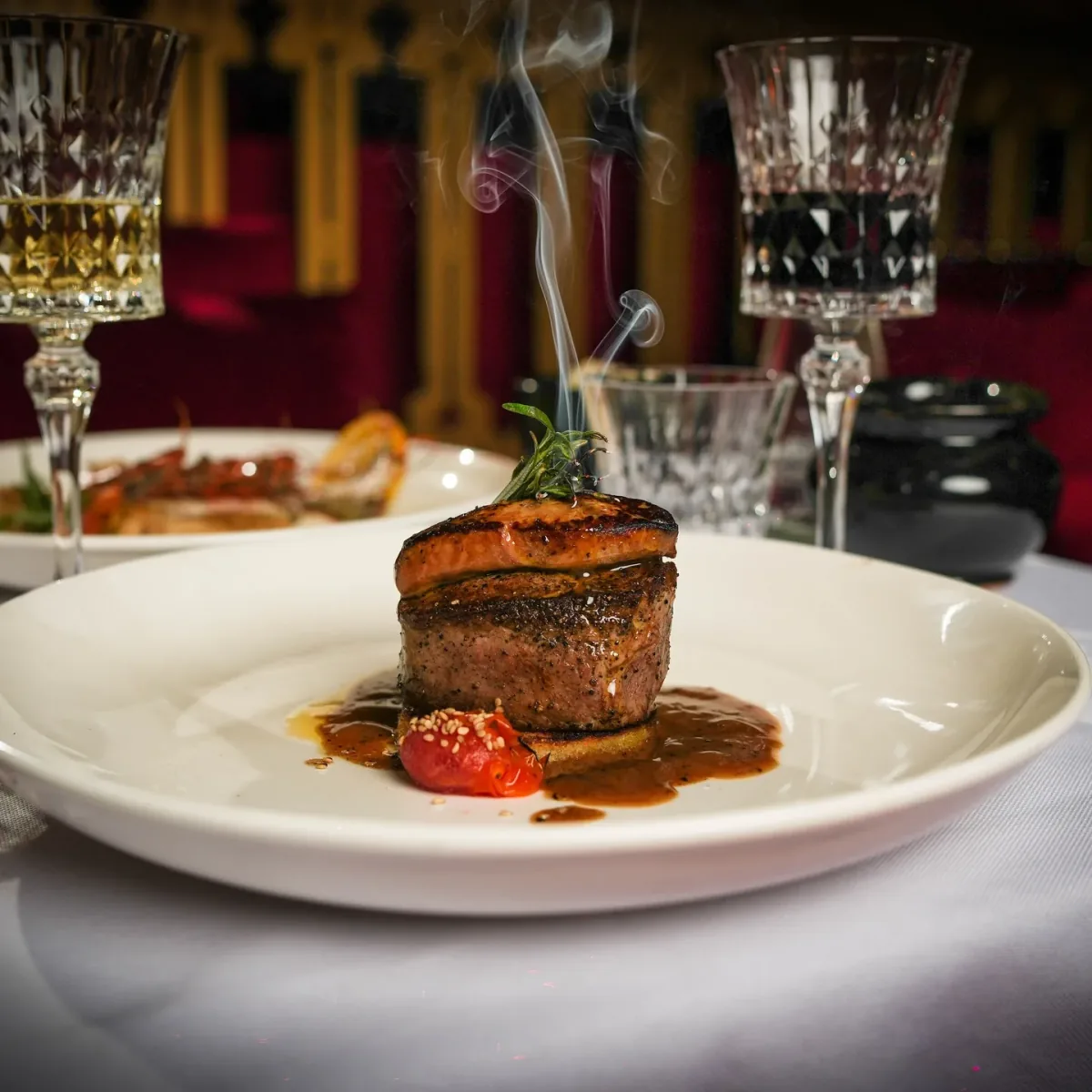 Beef fillet plated with sauce and served under glass at LOV